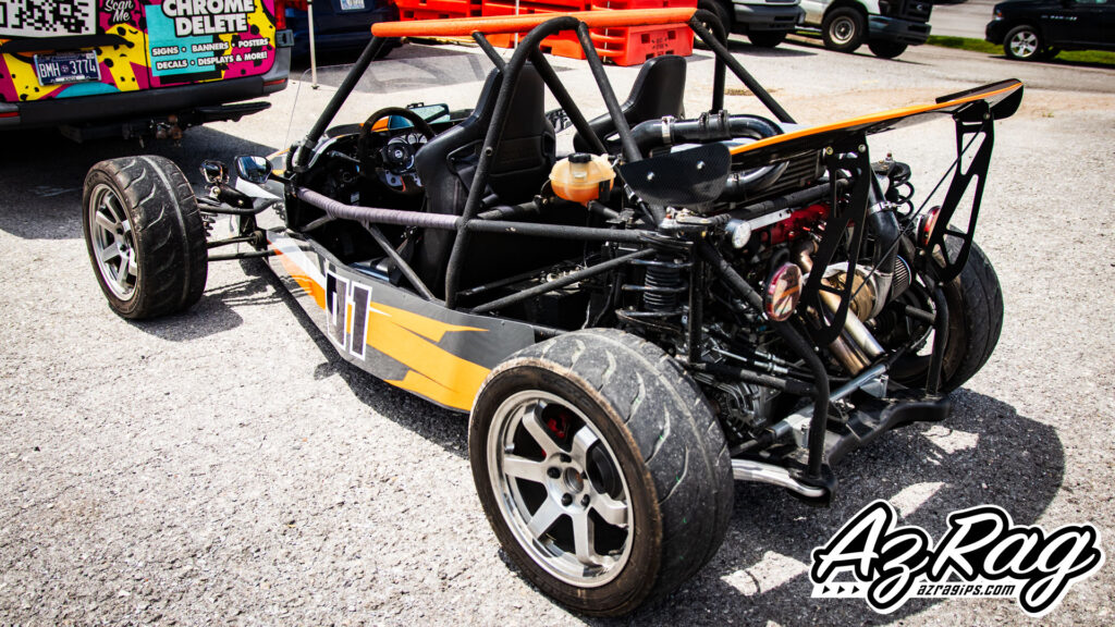 Goblin race car livery wrap rear three-quarter view orange graphics roll cage Knoxville
