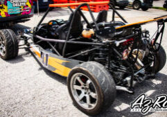 Goblin race car livery wrap rear three-quarter view orange graphics roll cage Knoxville